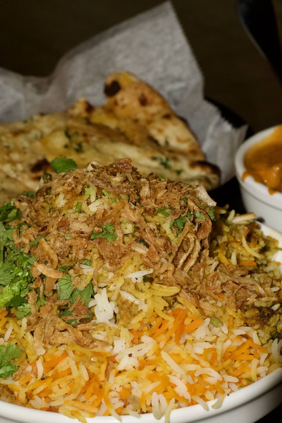 Biryani piled with crisp fried onions and cilantro