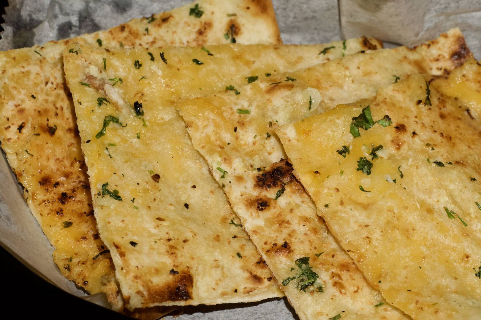 Cheese garlic naan scattered with cilantro